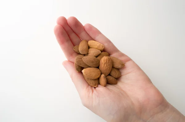 Woman 's Hand Holding Almonds — стоковое фото