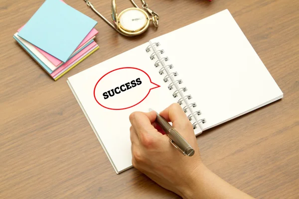 Hand writing SUCCESS word on a notebook with pen. — Stock Photo, Image