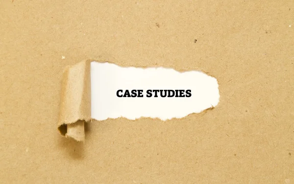 Case Studies words written under torn paper — Stock Photo, Image