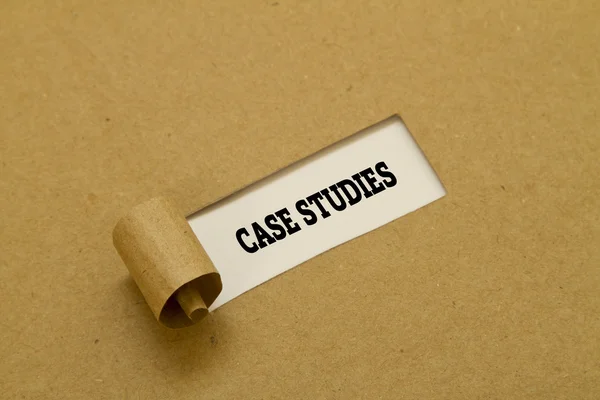 Case Studies words written under torn paper — Stock Photo, Image