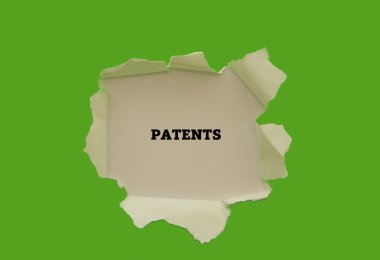 PATENTS inscription inside of hole in cardboard clipart