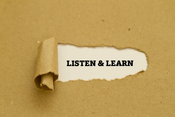 Фраза "Слушай и говори" написана на разорванной бумаге. — стоковое фото