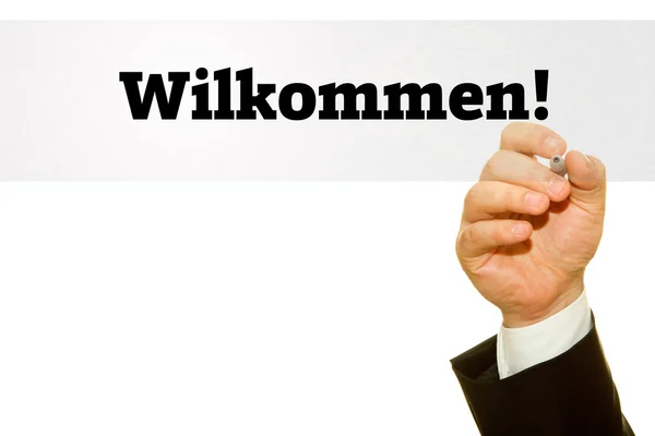 Hand schrijven Wilkommen! op een transparante wipe board. Welkomstbericht in Duitse taal. — Stockfoto