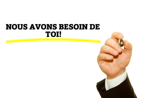 Hand writing French Slogan NOUS AVONS BESOIN DE TOI! (We Need You!) on a transparent wipe board. — Stock Photo, Image