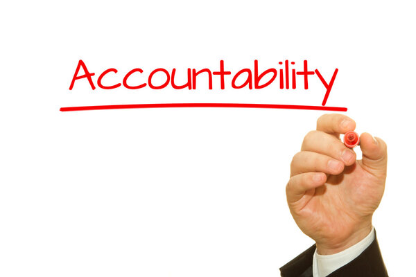 Businessman hand writing Accountability with a marker.