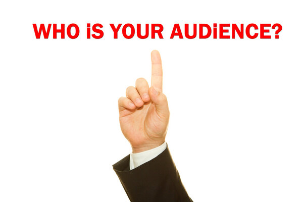 Businessman hand writing Who is your audience? question on a transparent wipe board