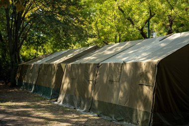 Budapest, Hungary - August 20, 2024: Army tent pitched in urban park during military exhibition