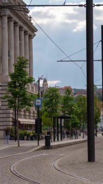 Budapeşte, Macaristan - 24 Mayıs 2025: Parlamento yakınlarında tramvay durağı. Zaman geçişi, kaydırma geçişi, dikey yönelim.