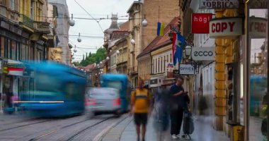 Zagreb, Hırvatistan - 23 Ağustos 2025: Zagreb 'deki Ilica Caddesi' nin zaman çizelgesi, yayaların ve yerel mağazalar ve kafelerle dolu tarihi cephelerin yanından geçen mavi tramvayların yer aldığı bir zaman çizelgesi.