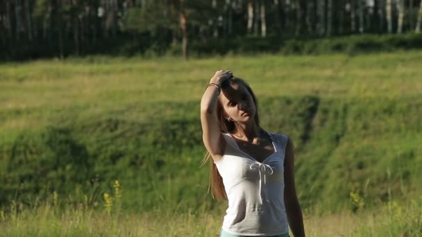 Young beautiful woman playing with her long hair, outdoors - outside. — Stock Video