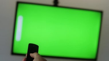 Adam televizyonun sesini bar, ev ya da ofis uzaktan kumandası ile açıyor. Yeşil Ekran TV.