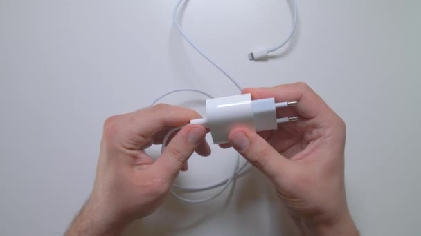 Hand plug USB-C charger adapter and wire into charger. New Apple power adapter. 02.09.2021 - Russia, Orel — Stock Video