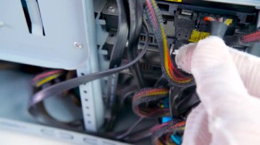Unplugging a 4-pin power and data cable from hard disk drive on a desktop PC.