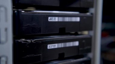 Cleaning hard disk drives rack from dust with an anti-static brush.