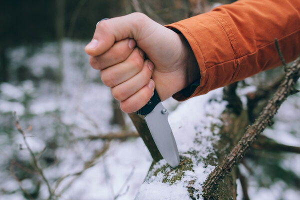 sharp pocketknife in a snowy woods 