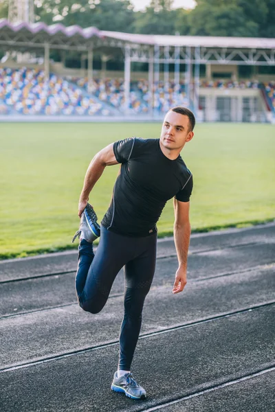 Man stretches before running — Stock Photo, Image
