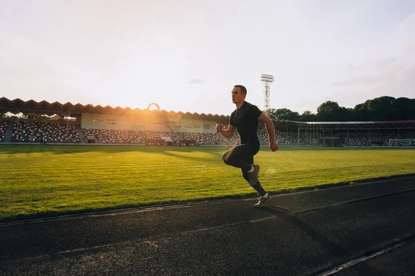 Runner on the track at a sport stadium — Stock Photo, Image