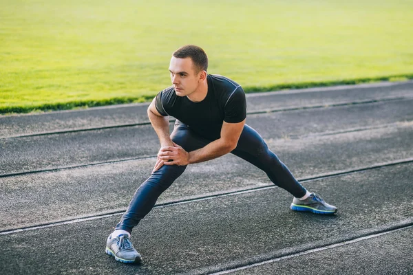 Man stretches the before running — Stock Photo, Image