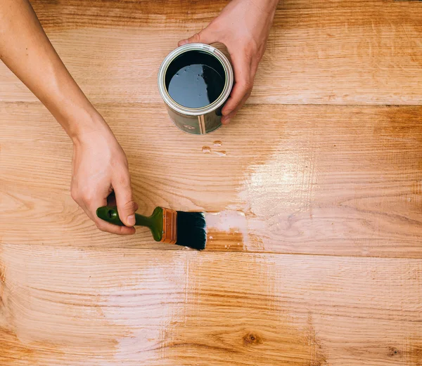 Wood texture, hand and paintbrush — Stock Photo, Image