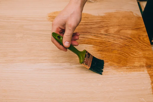 Wood texture, hand and paintbrush