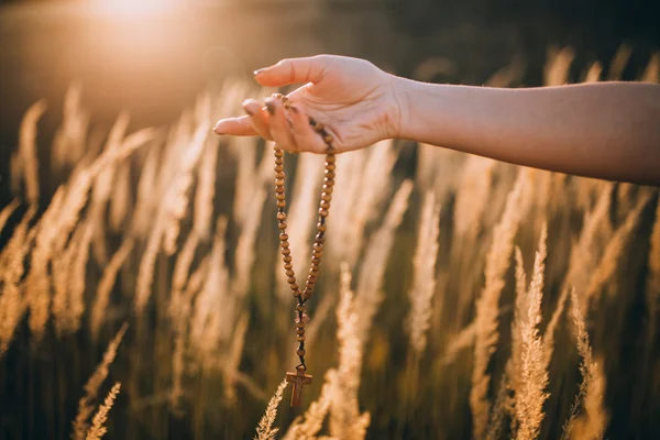 Wooden rosary In hand — Stock Photo, Image