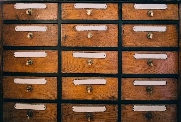 Wooden drawers with labels — Stock Photo, Image