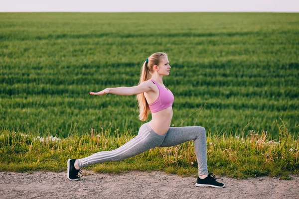 Blonde Frau dehnt den Körper — Stockfoto