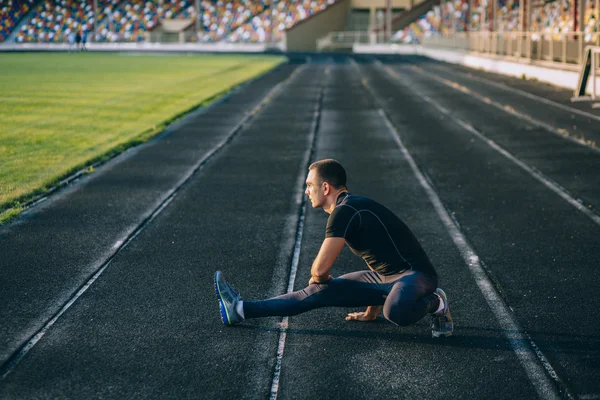 Man stretches before running — Stock Photo, Image