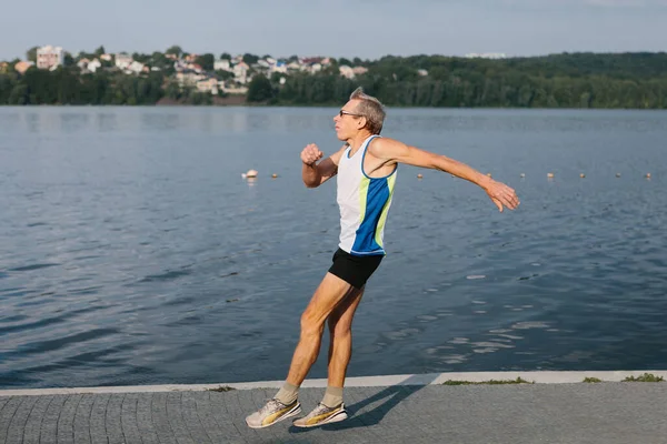 Older man is engaged in running in the fresh air — 스톡 사진