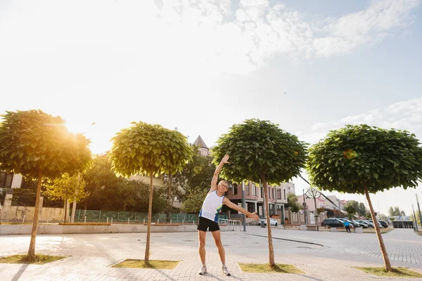 Signor man performs sports exercises in the park — 스톡 사진