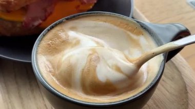 El köpük kahve kaşığı karıştırır, sağlığa dikkat eder. Dikkatli hazırlama kahvesi, sağlık durumu, hafif meşrubat, köpüklü bira. Sağlık bilinçli tercihler günlük yaşam sağlıklı yaşam tarzı taahhütleri