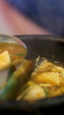 Biftekli ya da tavuklu Japon Ramen, kızarmış etli pilav, Tom Yum arka planda döner, yakın plan, dikey video. Baharatlı Tayland Asya çorbası, geleneksel Kore Çincesinde aşçı