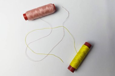 Beyaz arka planda sarı ve pembe iplikler kullanıldı.