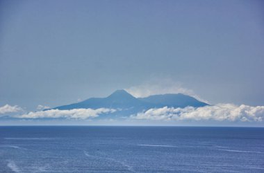Dreamy landscape in Cape Verde: volcanic island surroujnded by clouds.