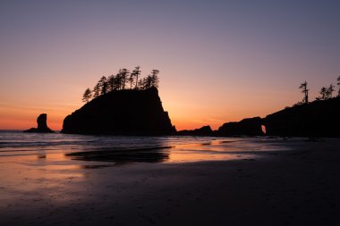 Günbatımı deniz yığında silüeti