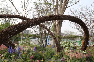 Bahçe, birbirine dolanmış sarmaşıklardan oluşan zarif ve benzersiz bir kemere sahiptir. Önlerinde iki uzun, kavisli ejderha kuyruğu oluşturur ve birbirlerine dolanarak büyük, eğri bir ağaç gövdesi oluştururlar..