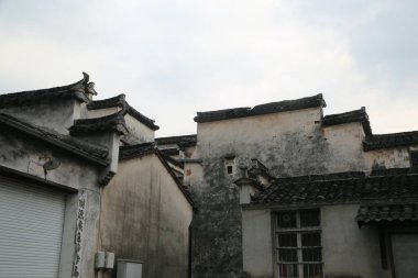 Eski köyde, bir tarafında beyaz duvarlar ve siyah fayanslar olan antik bir bina var. Onun yanında başka bir ev daha vardı. Çatı grimsi-beyaz renktedir, ve birkaç büyük saçağın eski kıyafetlerinden düşmüştür..