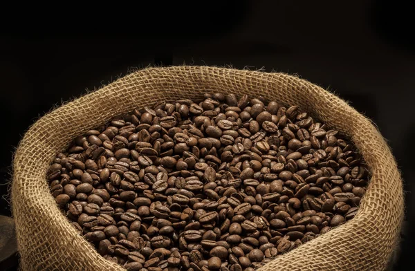 Coffee beans on burlap sack — Stock Photo, Image