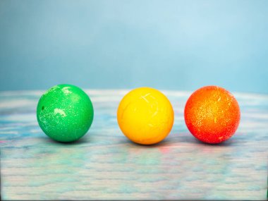 Mavi arka planda parlak renkli renkli Paskalya yumurtaları.