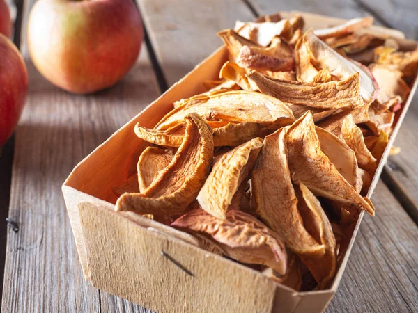 Basket with sugar-free apple chips in a wooden basket close-up