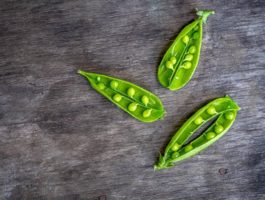 Açılmış taze bezelyeler ahşap bir masada