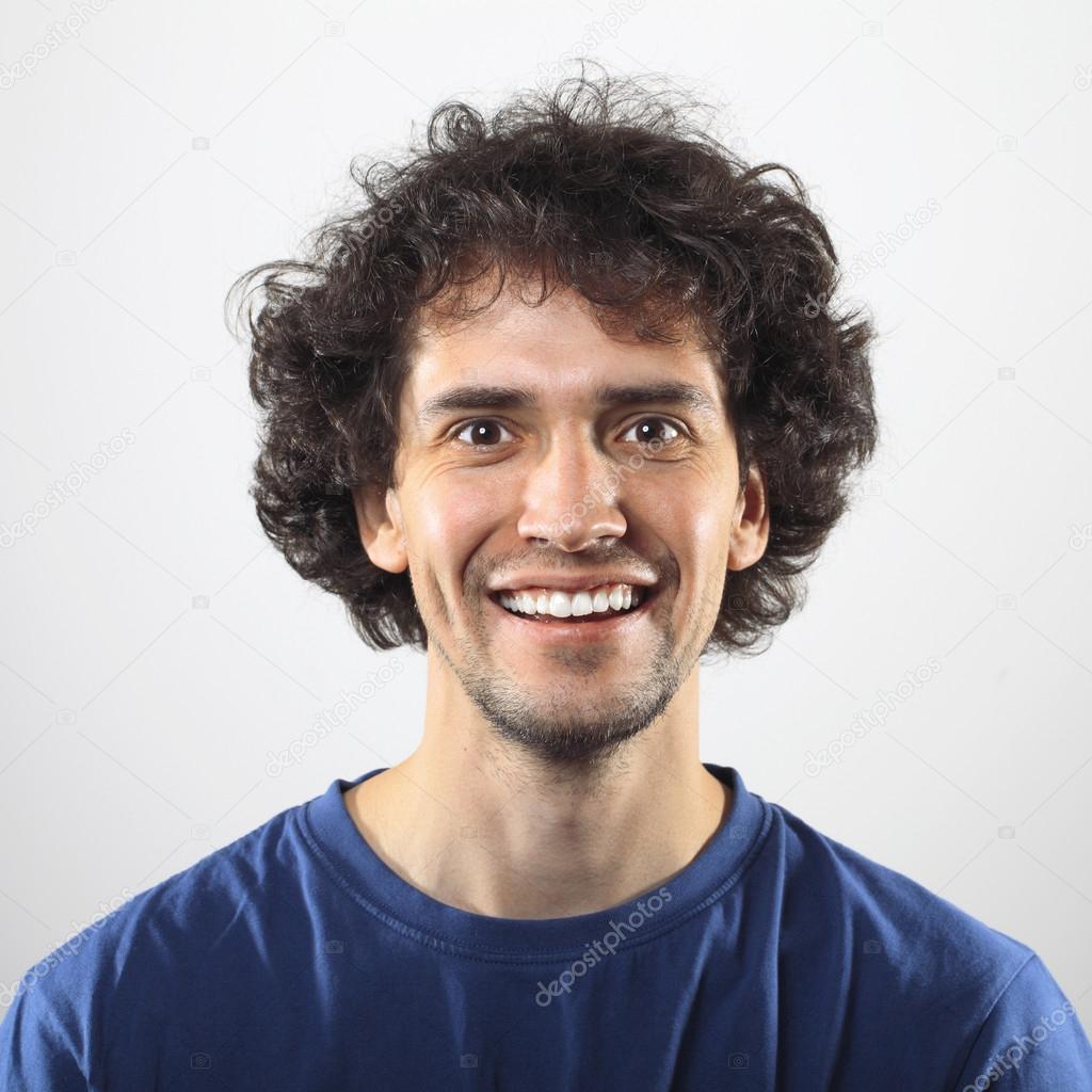 Happy young man portrait with toothy smile.