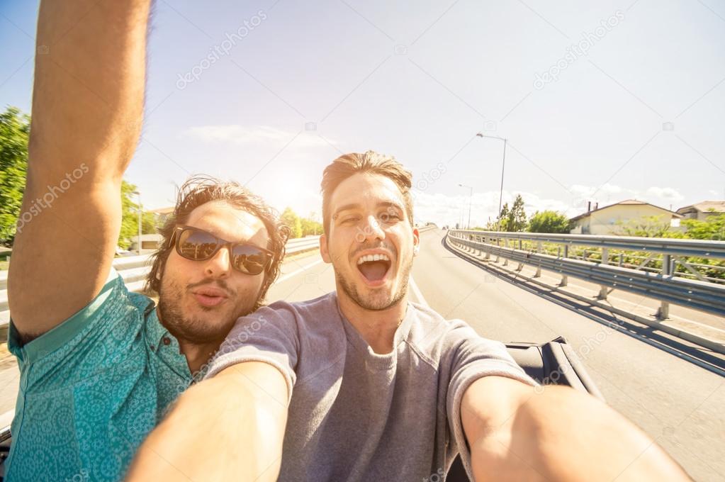 Friends taking selfie at car trip