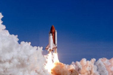 The launch of the space shuttle against the background of the sky and smoke. Elements of this image furnished by NASA. High quality photo clipart