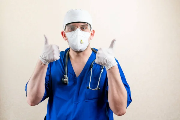Doctor in mask and cap, showing thumbs up. High quality photo