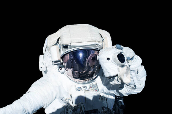 Astronaut in a spacesuit isolated on a black background. Elements of this image were furnished by NASA. High quality photo