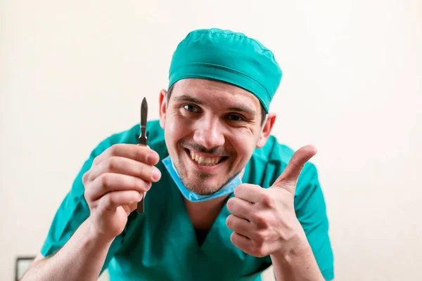 stock image Funny doctor with a scalpel in his hands.