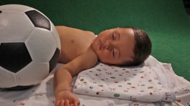 futbol ile uyuyan çocuk