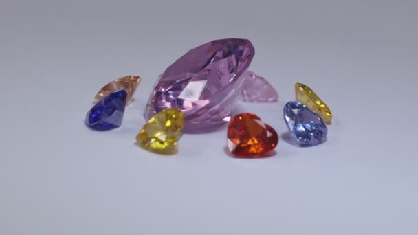 在五彩缤纷的心形钻石飞地中的钻石在白色的背景中回旋 心形珠宝是情人节的可爱礼物 — 图库视频影像
