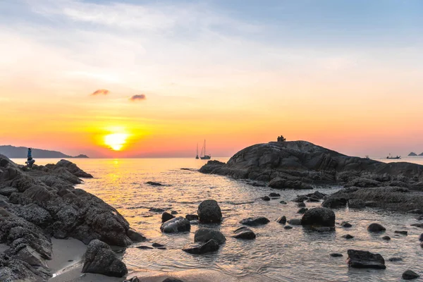 During the sunset, some people come to rest. Some come fishing on the rocks at Kalim Beach, next to Patong Beach, Phuket